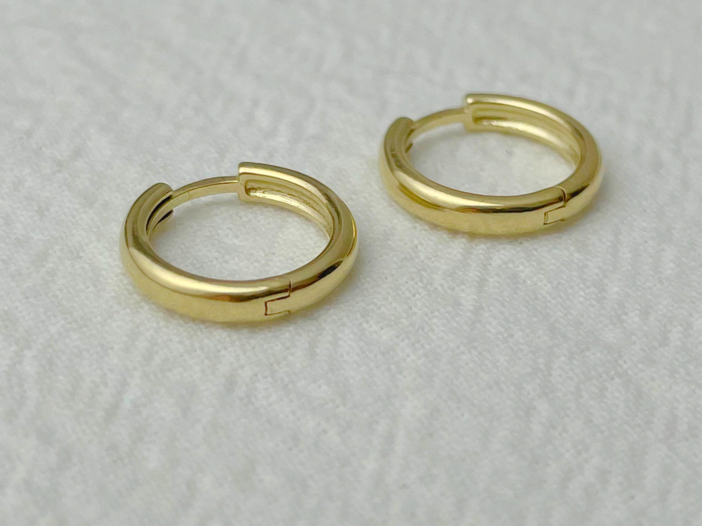 Elegant 14k gold earrings with a compact round shape and minimal design