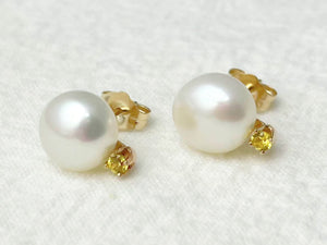 Pearl earrings with gold accents on a white background