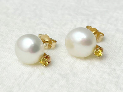 Pearl earrings with gold accents on a white background