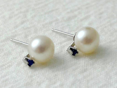 Pair of pearl earrings on a white background