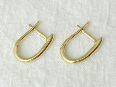 Pair of gold hoop earrings on a white background