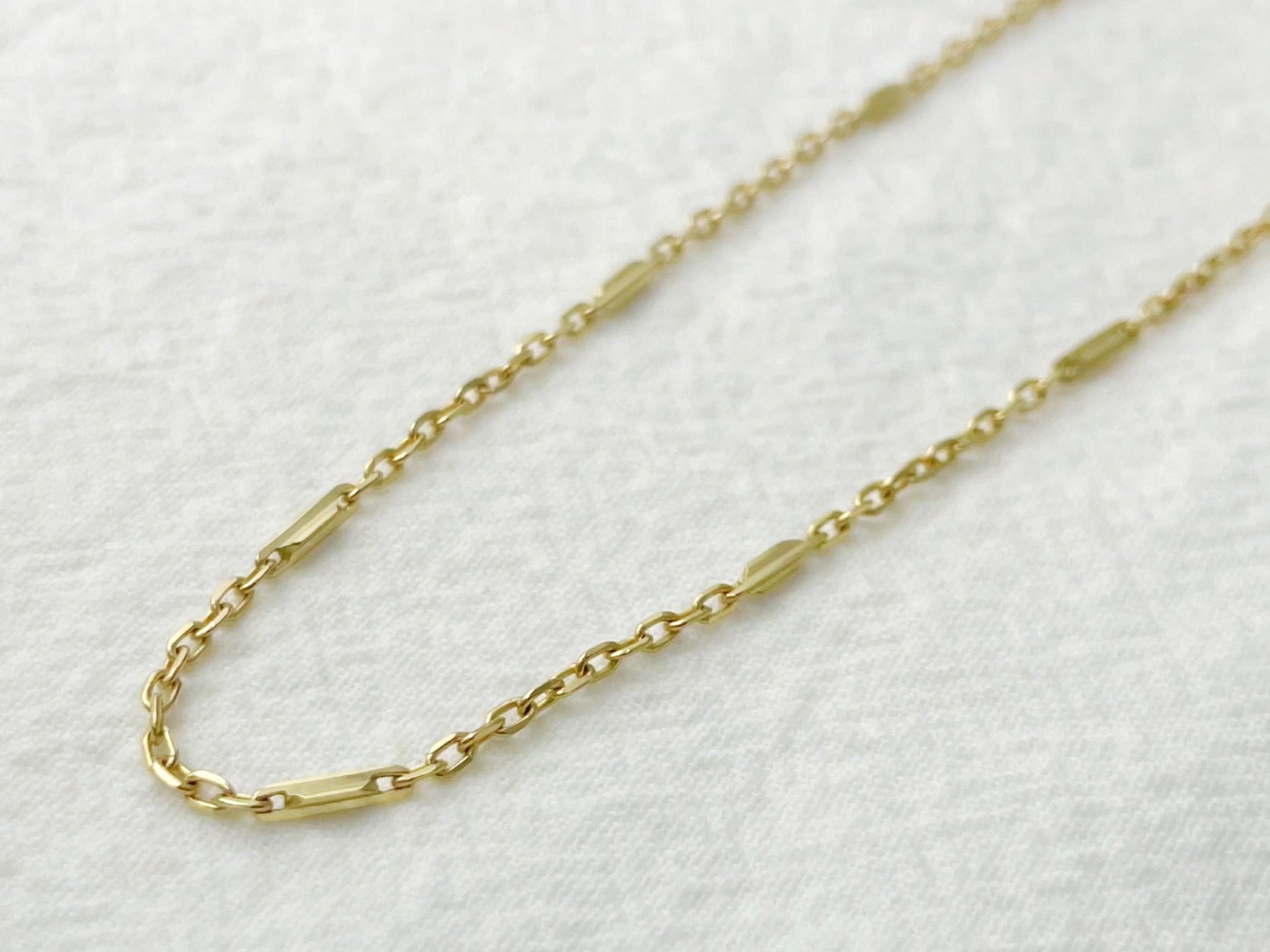 Gold chain necklace on a white background