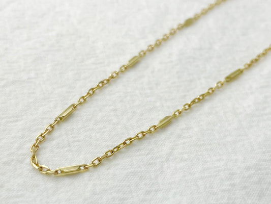 Gold chain necklace on a white background