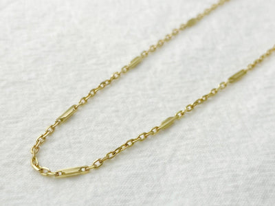 Gold chain necklace on a white background