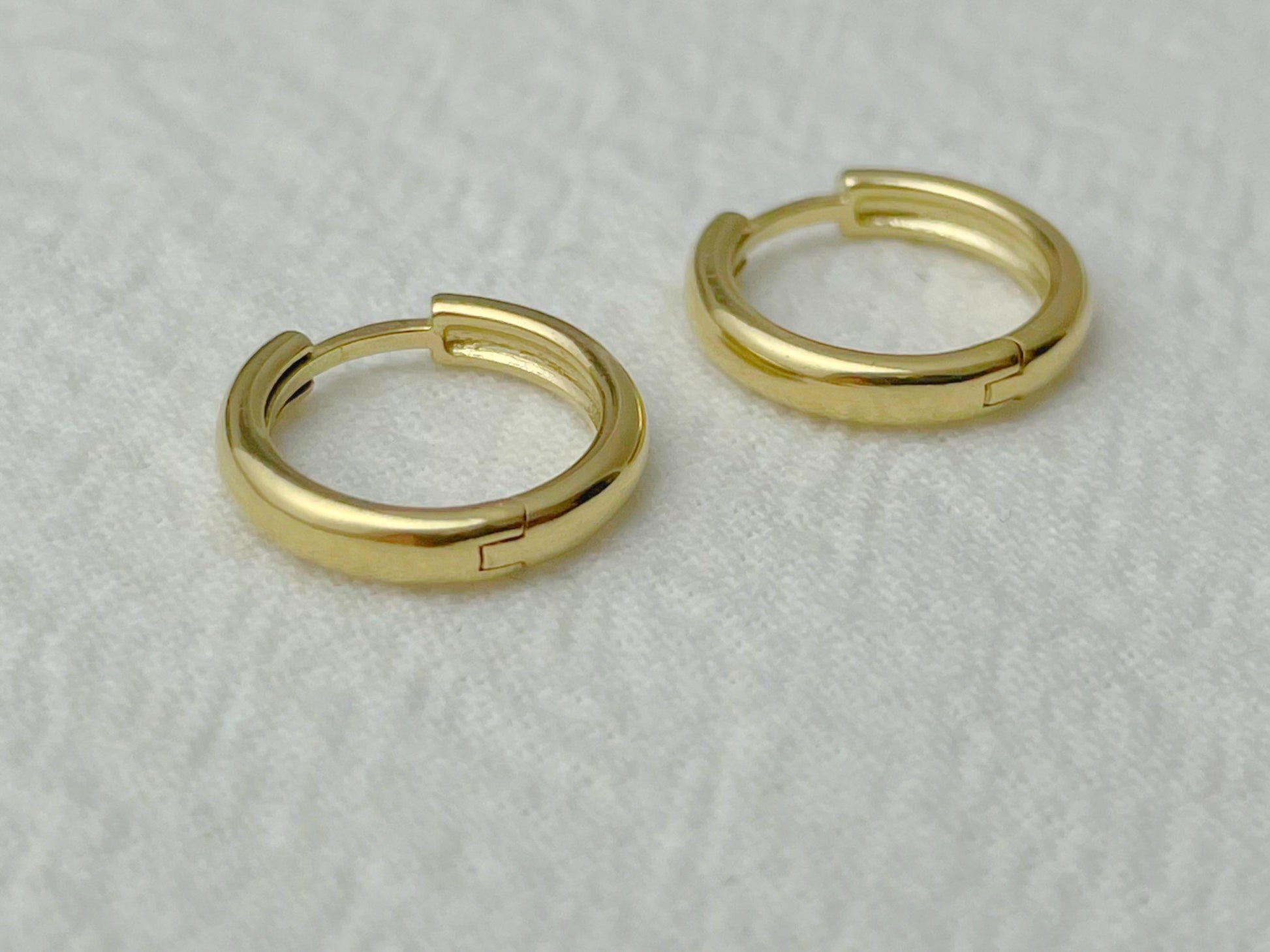 Elegant 14k gold earrings with a compact round shape and minimal design